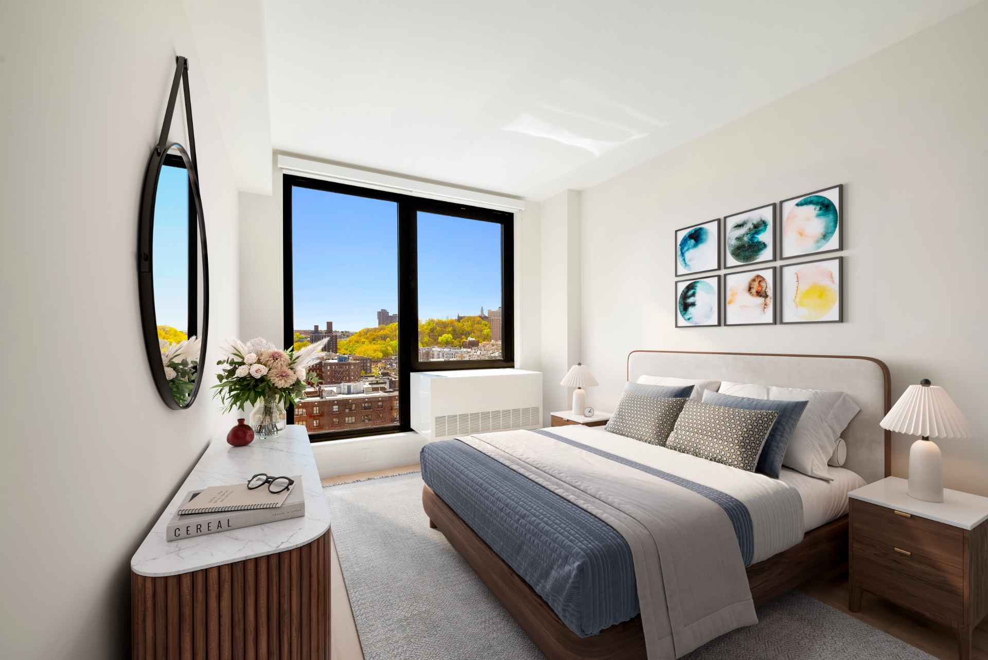 Modern bedroom with stylish decor & huge windows w/ park views at Tryon North, Inwood rentals near Fort Tryon Park.