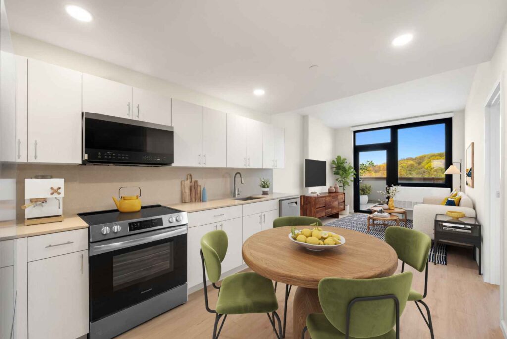Modern apartment living/dining room with stylish decor and door to terrace at Tryon North, Inwood apartments for rent.
