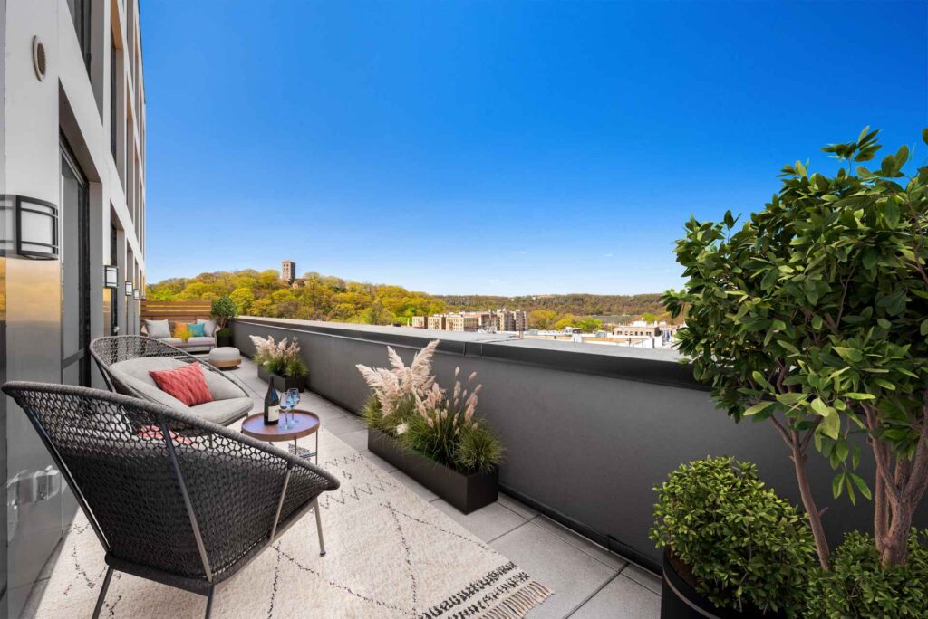Outdoor terrace at Tryon North apartments in Inwood, NYC with views of Fort Tryon Park.