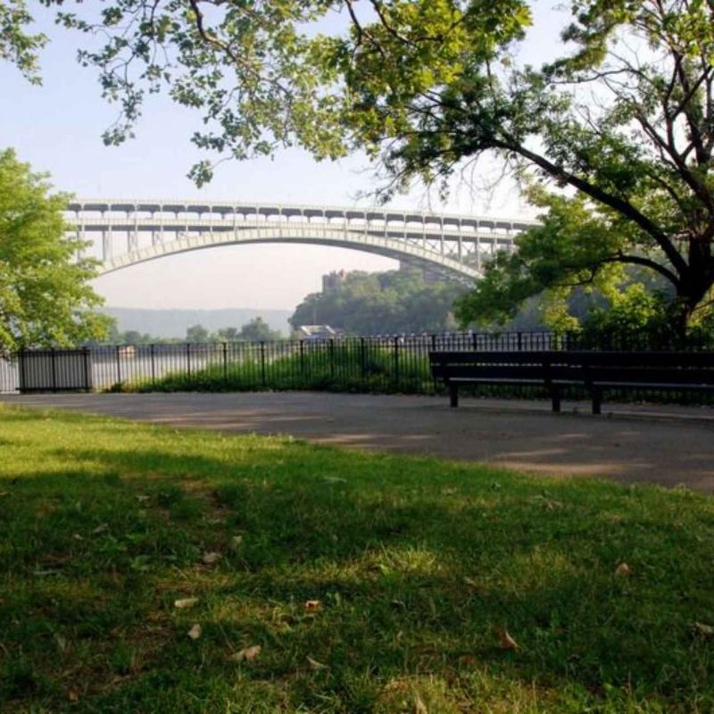 Inwood Hill Park near Tryon North apartments in Inwood NYC with view of bridge.