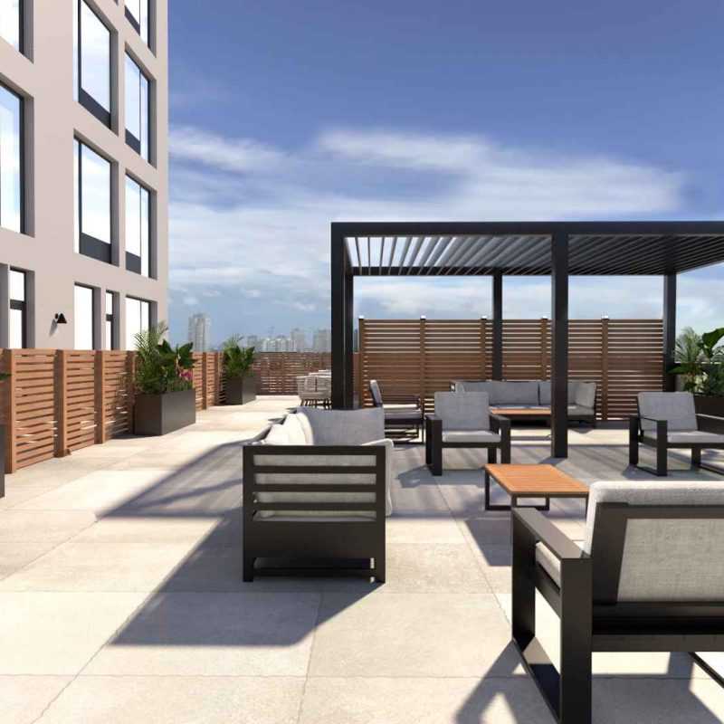 Rooftop terrace with lounge area and sweeping NYC and park views at Tryon North apartments in Inwood, Upper Manhattan.